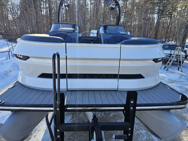 Slide: The Image of 2025 Sylvan M3 CLZ DC pontoon boat on trailer in snowy forest setting. - 4