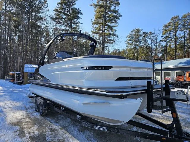 Slide: The Image of 2025 Sylvan M3 CLZ DC pontoon boat on trailer in snowy forest setting. - 5