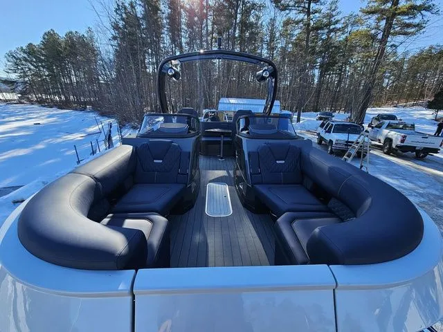 Slide: The Image of 2025 Sylvan M3 CLZ DC boat with luxurious seating, parked in a snowy forest setting. - 6