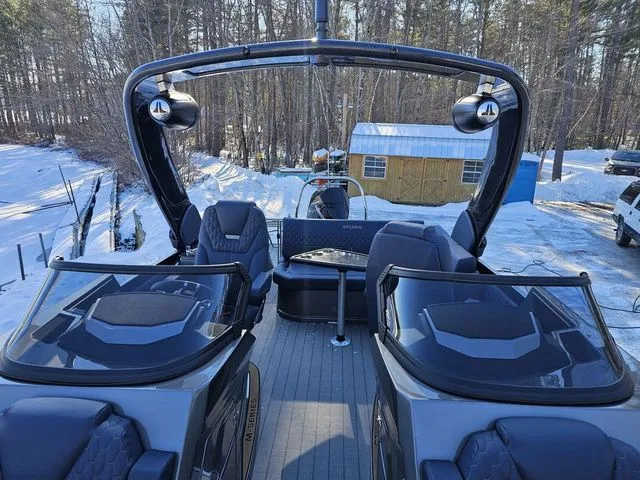 Slide: The Image of 2025 Sylvan M3 CLZ DC boat with dual consoles, set in a snowy forest backdrop. - 9