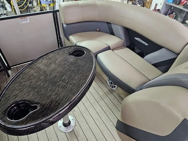 Slide: The Image of Luxurious interior of 2025 Sylvan Mirage X1 pontoon boat with plush seating and sleek table design. - 12