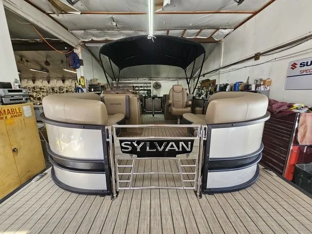 Slide: The Image of 2025 Sylvan Mirage X1 pontoon boat in a workshop setting. - 4
