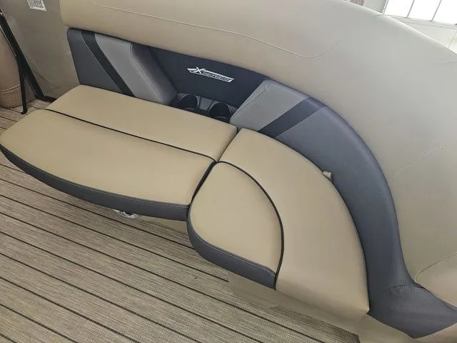 Slide: The Image of Luxurious seating on 2025 Sylvan Mirage X1 boat, featuring beige and gray upholstery. - 5