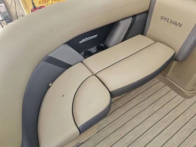 Slide: The Image of 2025 Sylvan Mirage X1 boat interior with beige and gray seating. - 6