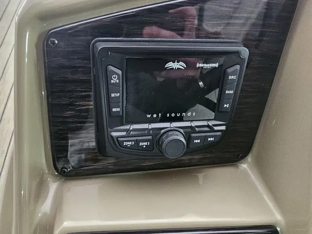 Slide: The Image of Control panel of a 2025 Sylvan Mirage X1 boat featuring a Wet Sounds audio system. - 8