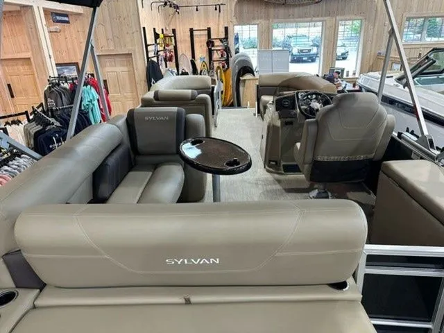 Slide: The Image of 2023 Sylvan 8524 CLZ pontoon boat interior with plush seating and modern dashboard. - 3
