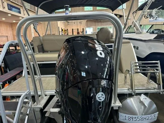 Slide: The Image of 2023 Sylvan 8524 CLZ pontoon boat with powerful 150 HP outboard motor in showroom. - 4