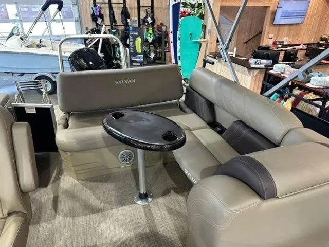Slide: The Image of 2023 Sylvan 8524 CLZ pontoon boat interior with seating and table. - 9