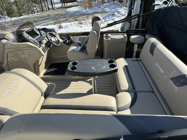 Slide: The Image of Interior of 2023 Sylvan L-3 DLZ BAR pontoon boat with beige seating and table. - 10