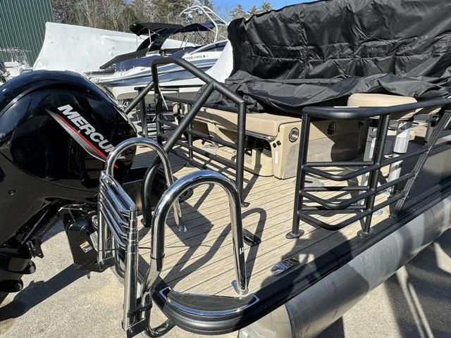 Slide: The Image of 2023 Sylvan L-3 DLZ BAR pontoon boat with Mercury engine, docked and covered. - 4