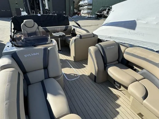 Slide: The Image of 2023 Sylvan L-3 DLZ BAR pontoon boat with luxurious beige seating and modern design. - 5