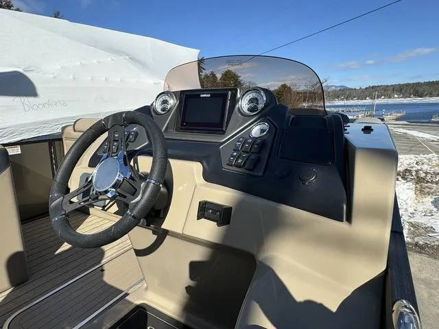 Slide: The Image of 2023 Sylvan L-3 DLZ BAR boat dashboard with steering wheel and control panel. - 7