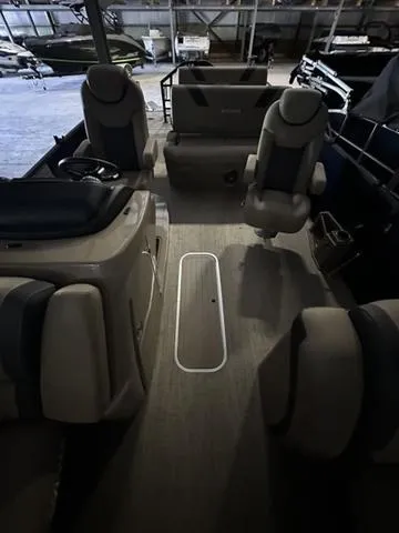 Slide: The Image of 2023 Sylvan L-3 DLZ pontoon boat interior with plush seating and modern design. - 4