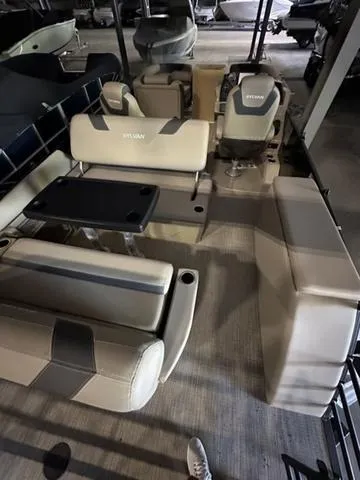 Slide: The Image of 2023 Sylvan L-3 DLZ pontoon boat interior with seating and table. - 5