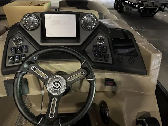 Slide: The Image of 2023 Sylvan L-3 DLZ boat dashboard with steering wheel and control panel. - 6