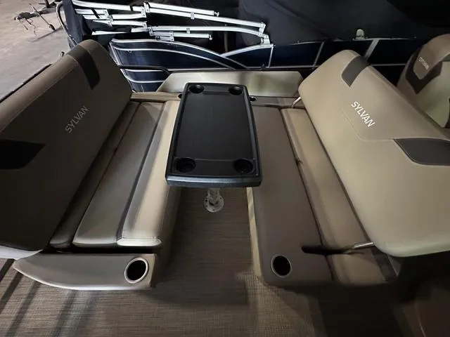 Slide: The Image of 2023 Sylvan L-3 DLZ boat interior with beige seating and central table. - 7