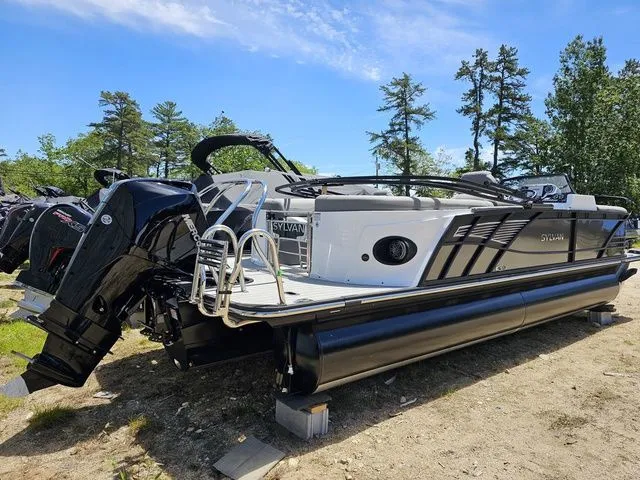 Slide: The Image of 2023 Sylvan S3 LZ pontoon boat with sleek design, parked outdoors under clear sky. - 4
