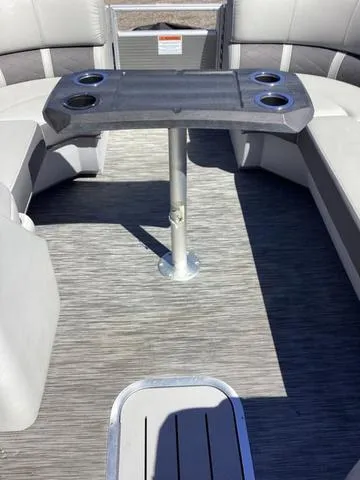 Slide: The Image of 2022 Bennington 24 LSRC boat interior with seating and table. - 12