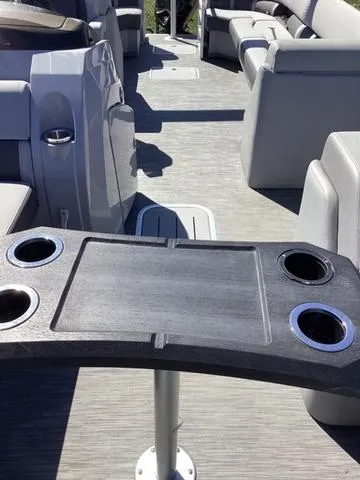 Slide: The Image of 2022 Bennington 24 LSRC boat interior with table and seating. - 14