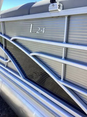 Slide: The Image of 2022 Bennington 24 LSRC pontoon boat with sleek silver and black design. - 15