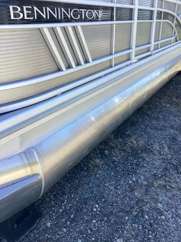 Slide: The Image of 2022 Bennington 24 LSRC pontoon boat side view, showcasing sleek aluminum design. - 16