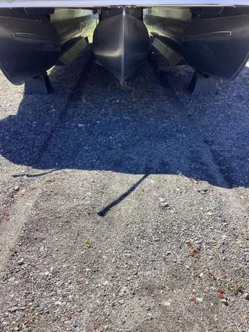 Slide: The Image of 2022 Bennington 24 LSRC pontoon boat hulls on gravel surface. - 17