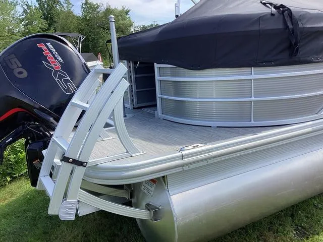 Slide: The Image of 2022 Bennington 24 LSRC pontoon boat with Mercury 150 engine, covered and docked. - 2