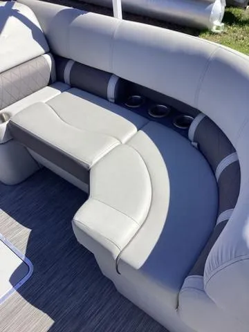 Slide: The Image of 2022 Bennington 24 LSRC boat interior with gray cushioned seating and cup holders. - 6