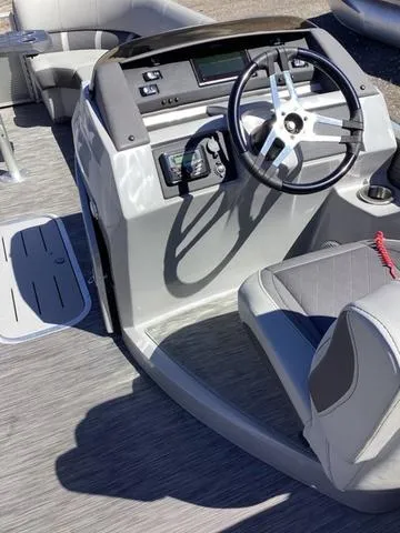 Slide: The Image of 2022 Bennington 24 LSRC boat interior with steering wheel and seating. - 7