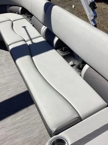 Slide: The Image of 2022 Bennington 24 LSRC boat interior with sleek, light gray seating and cup holders. - 8