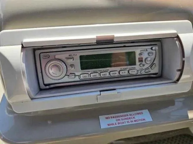 Slide: The Image of 2006 Sylvan Mirage 8520 boat stereo system with safety warning label. - 10