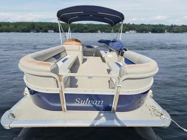 Slide: The Image of 2006 Sylvan Mirage 8520 pontoon boat on a lake with canopy and seating. - 2