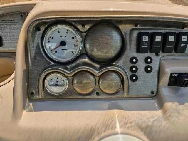 Slide: The Image of Dashboard of a 2006 Sylvan Mirage 8520 boat with gauges and switches. - 5