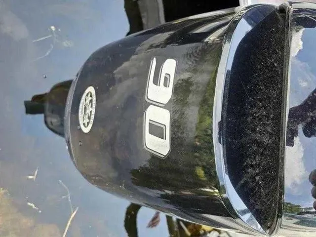 Slide: The Image of Outboard motor on water, featuring "90" marking, reflecting sky and surroundings. - 6