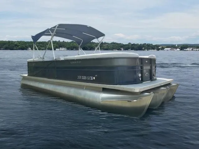 Slide: The Image of 2017 Crest 250 SL pontoon boat on a lake with canopy and scenic background. - 1