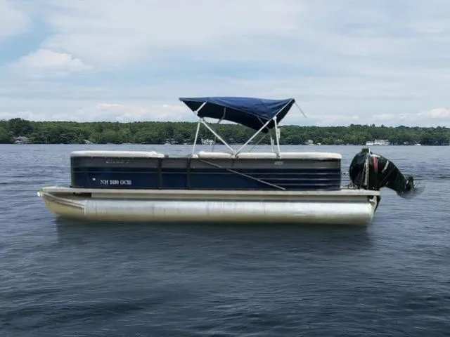 Slide: The Image of 2017 Crest 250 SL pontoon boat on a calm lake with blue canopy. - 13