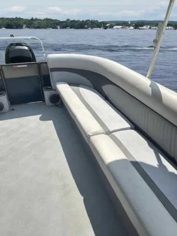 Slide: The Image of 2017 Crest 250 SL boat interior with seating, on a calm lake. - 14