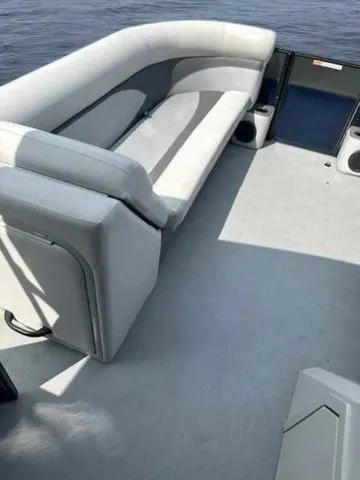 Slide: The Image of 2017 Crest 250 SL boat interior with gray seating and open deck on the water. - 15