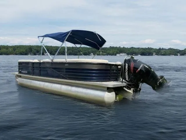 Slide: The Image of 2017 Crest 250 SL pontoon boat with canopy on a lake. - 2