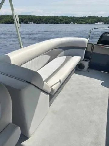 Slide: The Image of 2017 Crest 250 SL pontoon boat with spacious seating on a calm lake. - 5
