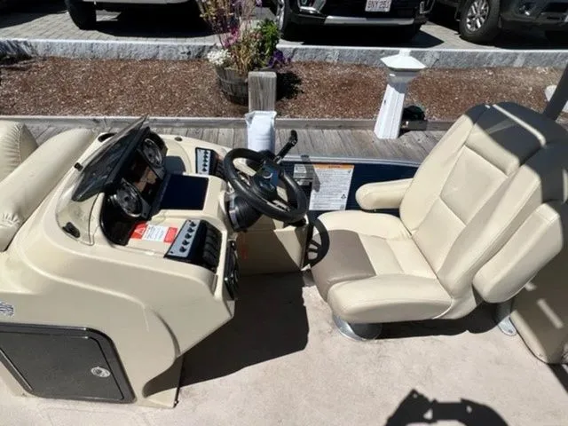 Slide: The Image of 2019 Godfrey Pontoons SWPE 255 WB TT-25 helm with beige captain's chair and control panel. - 10