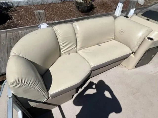 Slide: The Image of 2019 Godfrey Pontoons SWPE 255 WB TT-25, beige seating on deck, shadow visible. - 11
