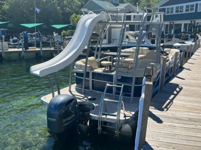 Slide: The Image of 2019 Godfrey Pontoons SWPE 255 WB TT-25 with slide, docked by a lakeside. - 3