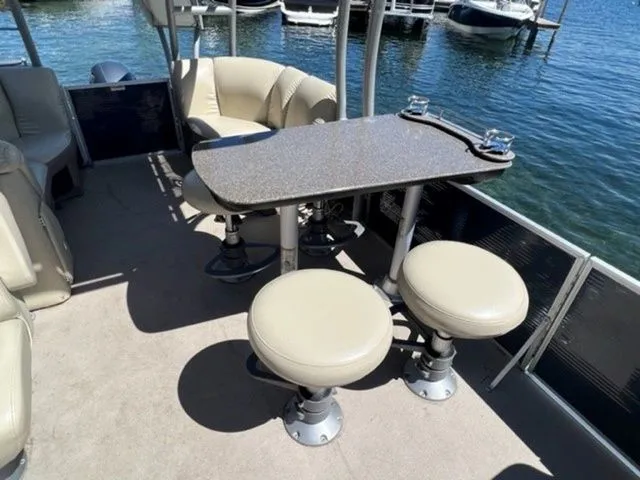 Slide: The Image of 2019 Godfrey Pontoons SWPE 255 WB TT-25 interior with seating and table on water. - 8