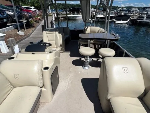 Slide: The Image of 2019 Godfrey Pontoons SWPE 255 WB TT-25 at dock, featuring spacious seating and table. - 9