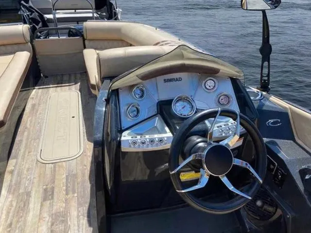 Slide: The Image of 2017 Crest Savannah 250 NX L boat interior with steering wheel and dashboard on water. - 7