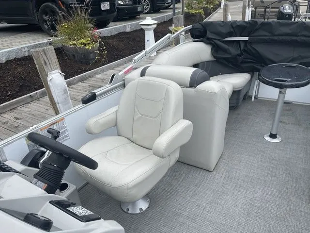 Slide: The Image of 2022 Sylvan 8522 LZ boat interior with plush seating and steering wheel. - 10