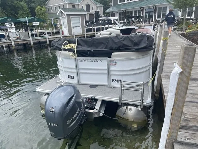 Slide: The Image of 2022 Sylvan 8522 LZ pontoon boat docked with Yamaha 115 outboard motor. - 3