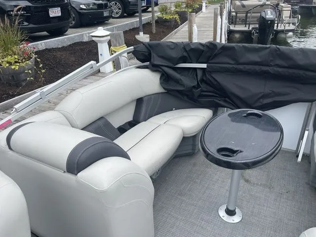 Slide: The Image of 2022 Sylvan 8522 LZ pontoon boat interior with seating and table at dock. - 5