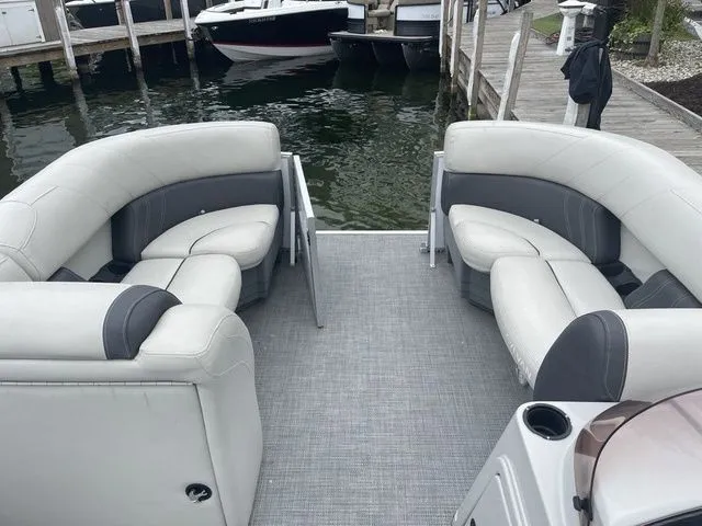 Slide: The Image of 2022 Sylvan 8522 LZ pontoon boat with spacious seating at a dock. - 9